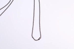 Detailed view of dark bronze metal ball chain necklace with secure connector clasp