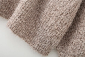Close-up of brown alpaca wool blend knitwear with fluffy texture and ribbed pattern