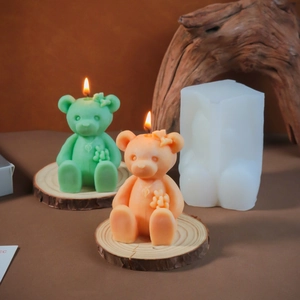 Detail of sitting bear silicone mold with colorful bow-tie candles and flower details