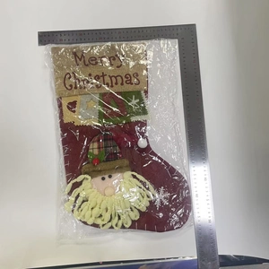 Macro view of a 50cm red Christmas stocking with burlap top and Santa applique