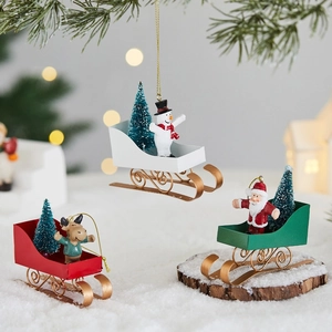 Three Christmas sled hanging decorations with Santa, reindeer and snowman figures