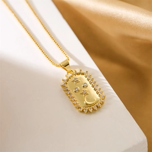Detailed view of gold rectangle pendant necklace with zircon stars and moon on silk