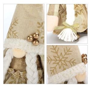 Detail of Christmas gnome with golden snowflake patterns and white braided plush hair