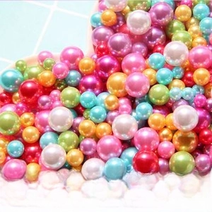 Macro shot of assorted colorful high-gloss ABS no-hole pearls for DIY crafts