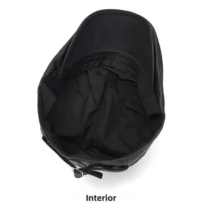 Detail of the internal black fabric lining and adjustable strap on the leather newsboy cap