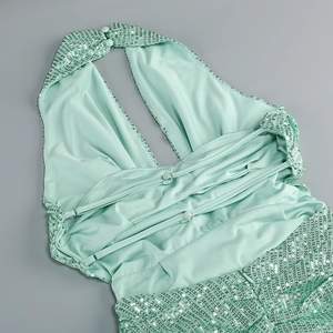 Detail of mint green sequin evening gown showing halter neck and back strap design