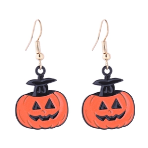 Detail of Halloween pumpkin earrings with black wizard hats and golden hooks