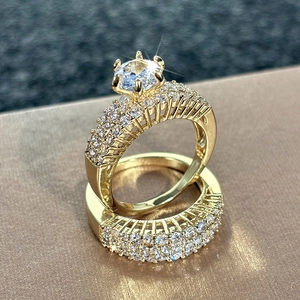 Close-up of luxury gold-plated two-piece bridal ring set with sparkling zircon micro-paving