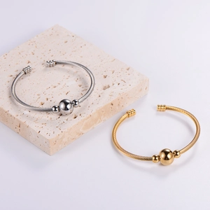 Detailed shot of adjustable twisted wire cable bracelets in gold and silver finish