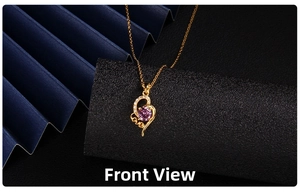 Close-up of gold heart pendant necklace featuring purple zircon and LOVE engraving