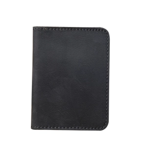 Detailed view of black genuine leather card holder with vertical grain and fine stitching