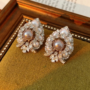 Macro view of vintage silver earrings with pink pearls and shimmering rhinestone crystals