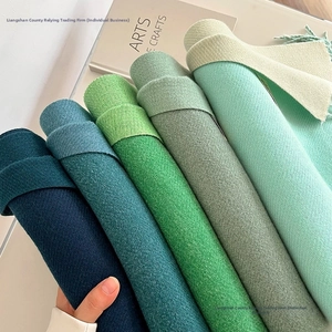 Detailed view of soft cashmere-like scarves showing diagonal weave and colorful fringes