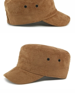 Detail of brown faux suede cadet hat showing metal eyelets and double-stitched seams