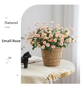 Pink artificial rose bouquet in woven basket on marble table for home decoration
