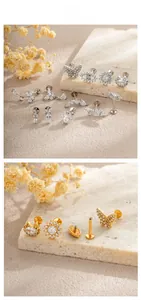 Detailansicht von Titanstahl-Zirkonia-Ohrsteckern in verschiedenen Schmetterlings- und Blumenformen