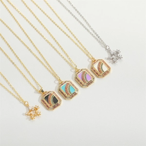 Detailed close-up of rainbow zircon inlaid square and star pendants on gold and silver chains