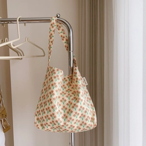 Detail of vintage orange floral cotton tote bag with side label and wide shoulder strap