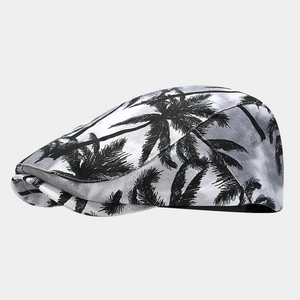 Side view detail of a retro flat cap featuring tropical palm tree print on light background