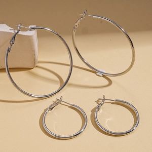 Minimalist silver geometric hoop earrings in small and large sizes with a polished finish