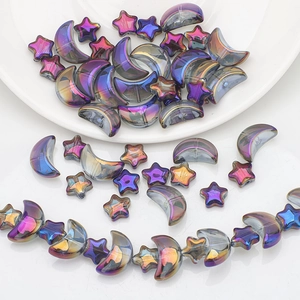 Macro shot of iridescent glass aurora moon and star beads for DIY jewelry making