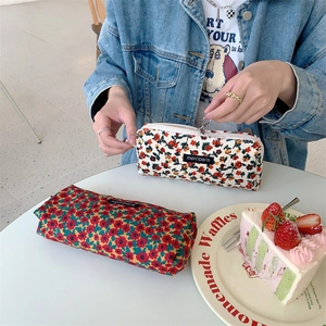 Detail of vintage floral corduroy pencil cases with zippers and retro merciparis labels