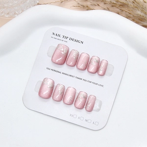 Pink purple cat eye press-on nails with silver leaf 3D design on a white display card