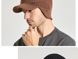Detail of caramel knit visor beanie with ear flaps and metal jeans logo for winter warmth