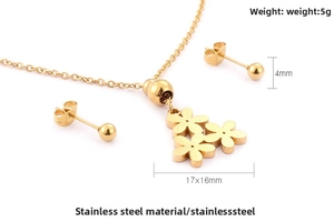 Close-up of 18K gold daisy necklace and 4mm stud earrings set in stainless steel
