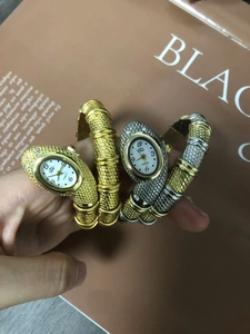 Macro detail of snake-shaped wrap quartz watch with crystal embellishments on wrist
