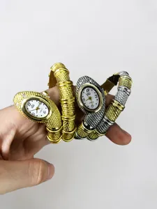 Macro detail of snake-shaped wrap quartz watch with crystal embellishments on wrist
