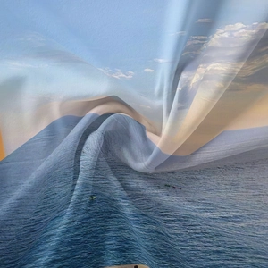 Detail of glossy polyester fabric featuring a realistic ocean scenery print and smooth texture