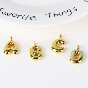 Balloon style gold alphabet pendants A B C D on white background for hip hop necklaces