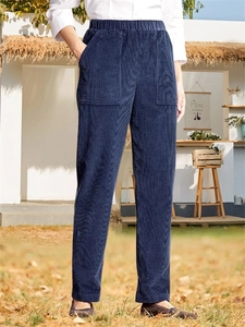 Detail of dark blue corduroy casual trousers with elastic waist and large front pockets