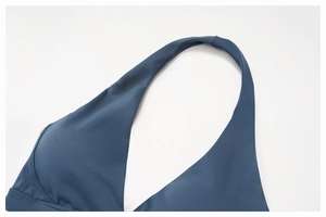 Detail shot of the halter neck strap and reinforced stitching on the navy sports bra
