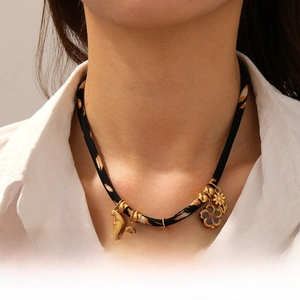 Close-up of bohemian leopard pattern necklace with gold moon and camellia flower charms
