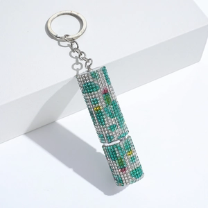 Detail of colorful rhinestone cylinder keychain with floral patterns and silver ring