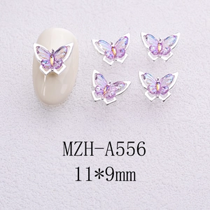 Macro detail of 11x9mm aurora purple butterfly nail art charms with silver metal borders