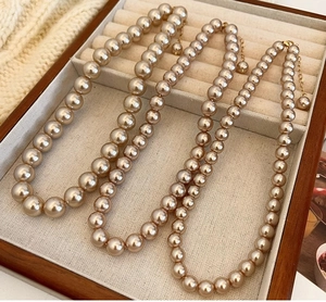 Detailed view of champagne pearl necklace set with golden adjustable metal chains