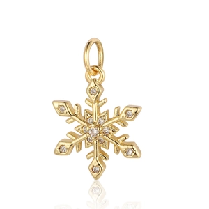 Macro shot of gold snowflake pendant with clear crystals and a metallic finish