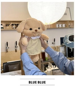 Detailed view of a cute plush dog wearing a yellow lace dress in a warm setting