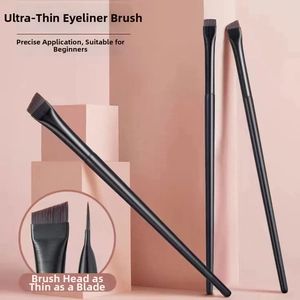 Macro detail of ultra-thin eyeliner brush with precise angled bristles and matte black handle