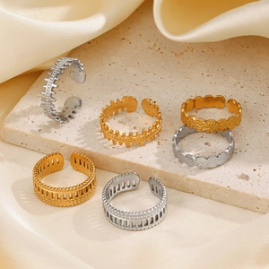 Chic stainless steel zipper and fishbone rings in gold and silver on marble surface