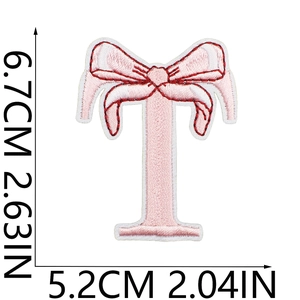 Pink embroidered letter T patch with bow detail and size dimensions measurement