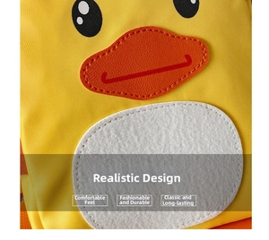 Detail view of yellow canvas toddler backpack with cute duck embroidery and leather beak