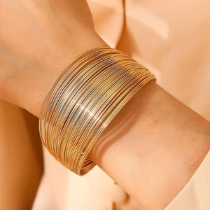 Exaggerated golden multi-layer stackable bangle set for women with polished metal finish