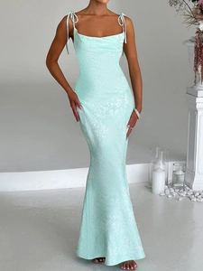 Detail of elegant mint green bodycon evening dress with textured jacquard fabric and thin straps