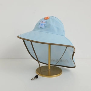Detail of light blue kids sun hat with neck flap and cute cartoon bear patch