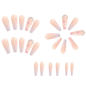 Detail of long pink gradient press-on nails with 3D butterfly and rhinestone accents
