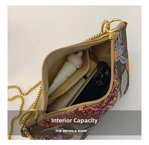 Detail view of the spacious inner compartment with floral embroidery and sequins